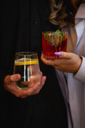 A woman holding a cocktail glass for a celebration with friends.の写真素材