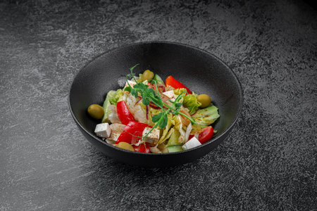 Caesar salad with croutons, cherry tomatoes, olives, cucumber and red onionの写真素材