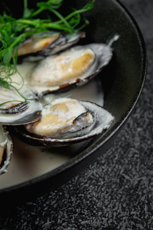 Fried mussels with crouton in a dark plateの写真素材