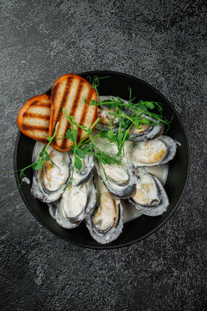 Fried mussels with crouton in a dark plateの写真素材