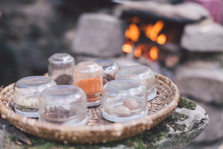 condiments for coffee on a straw plate standing on a stone in field kitchenの写真素材