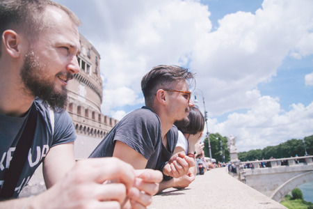 Friends stopped to have a rest during walk in Romeの写真素材