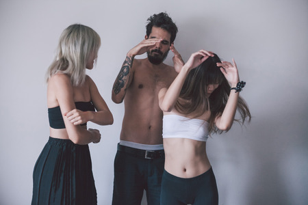 three people dancing behind the wallの写真素材