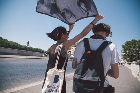 girl and boy walking on the street in Romeの写真素材