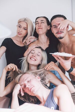 friends are taking funny photos in the kitchenの写真素材