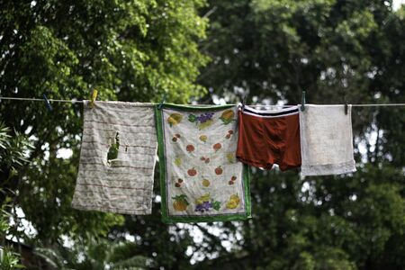 old clothes hanging on the ropeの写真素材