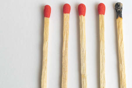 five wooden matches one burnedの写真素材