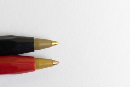 Red and black pens tips on white background macro photographyの写真素材