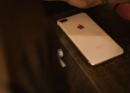 Jaisalmer, Rajasthan / India - CIRCA July 2020 : apple iphone and apple airpods on a brown textured backgroundのeditorial素材