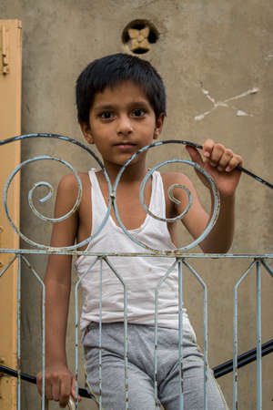 jaisalmer, rajasthan / india - july 25 2020 : kid swinging on a rope in the balcony of his houseのeditorial素材