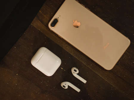 Jaisalmer, Rajasthan / India - CIRCA July 2020 : apple iphone and apple airpods on a brown textured backgroundのeditorial素材