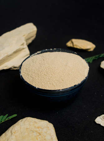 organic dry clay powder on white background. natural clay powder for cosmetic industry, spa or home useの写真素材