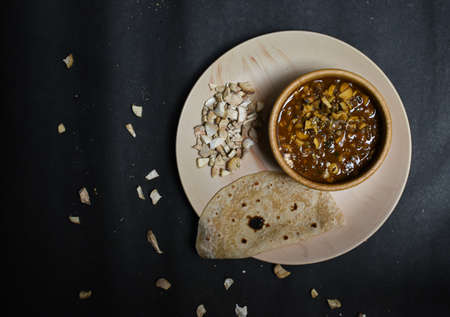 seasonal mushroom vegetable with bread/chapati on a black backgroundの写真素材