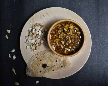 seasonal mushroom vegetable with bread/chapati on a black backgroundの写真素材
