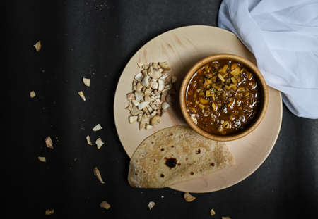 seasonal mushroom vegetable with bread/chapati on a black backgroundの写真素材