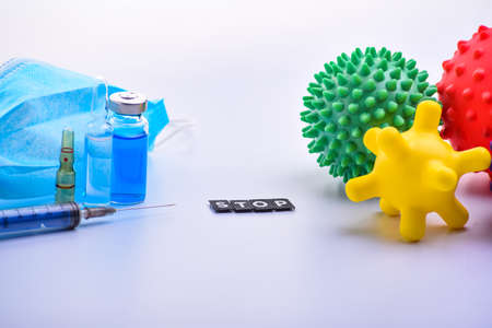 medical mask, syringe and medical ampoules. Children's toys represent viruses. stop inscription. virus protection conceptの写真素材