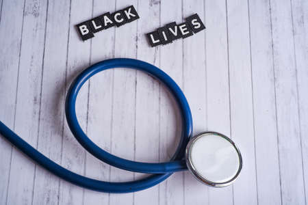 stethoscope and inscription black lives on a white wood backgroundの写真素材