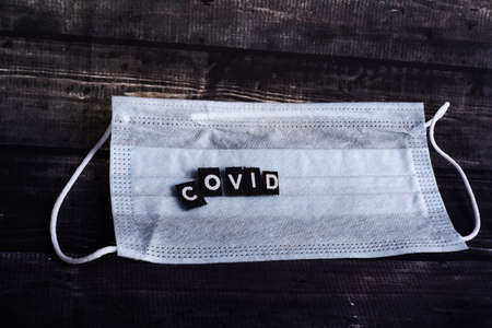 Coronavirus concept. Global call to stay home. medical mask STOP COVID. Mask with STOP SIGN....