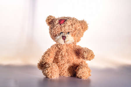sad teddy bear isolated on white backgroundの写真素材