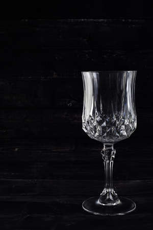 Copy space empty glass of wine on black backgroundの写真素材