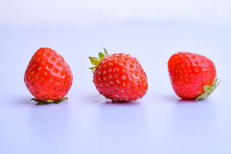 ripe strawberries isolated on white background with a reflection of a close-up