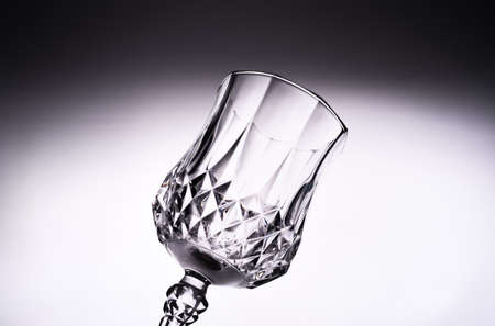 Close up of empty clean transparent Glass goblet against white background.