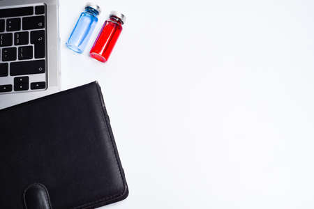 Doctor's office with modern workplace in medical clinic. Laptop, medicine ampoules and notepad on...