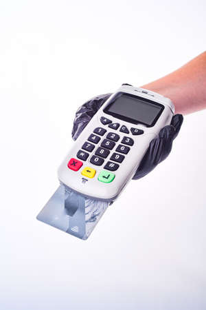 Payment terminal. Hand in glove. Safe shopping conceptの写真素材
