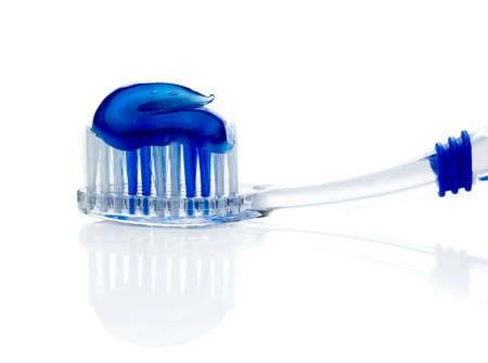 Toothpaste on blue toothbrush