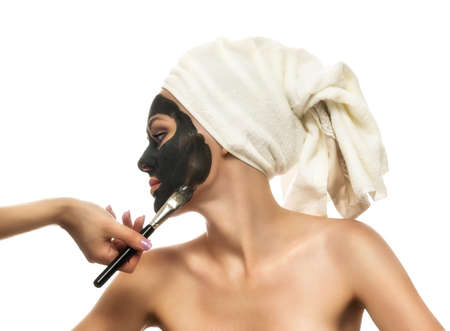 Woman receiving a mud mask の写真素材