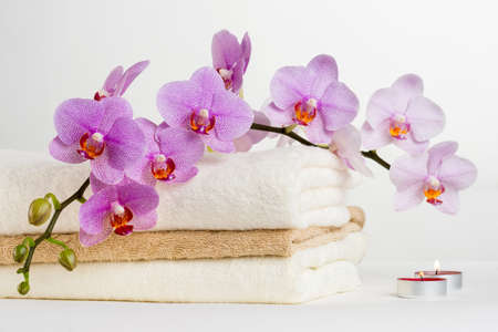 Health spa and flower orchid  Spa treatment - relax with candles  Relaxation and wellness objects including candles, towel and massage tool for personal well-being and health の写真素材