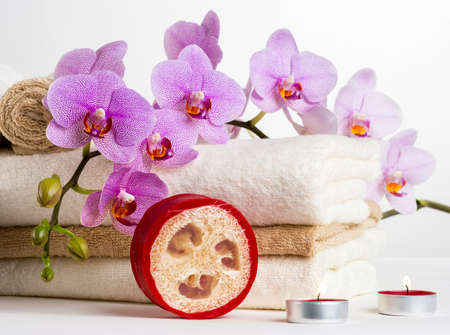 Health spa and flower orchid  Spa treatment - relax with candles  Relaxation and wellness objects including candles, towel and massage tool for personal well-being and health の写真素材