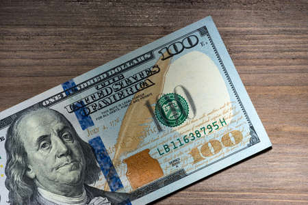 New hundred Dollar Bills on wooden backgroundの写真素材