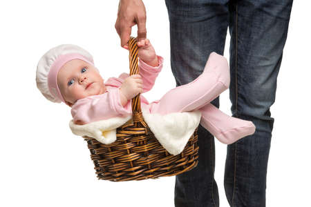 A man carrying a basket with a cheerful babyの写真素材
