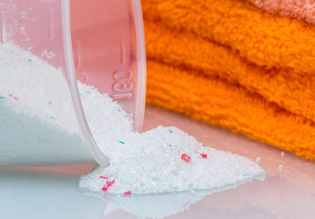 Detergent for washing machine in laundry with towels in the white background の写真素材