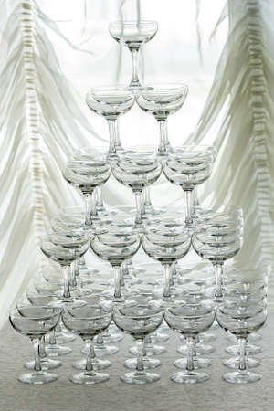 Pyramid holiday of champagne glasses on table in party