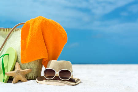 Beach slippers, towel and starfish on wood background  Concept of leisure and travelの写真素材