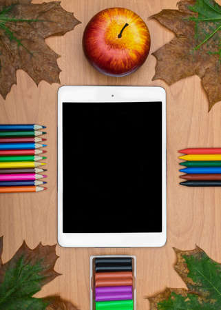 Back to School concept . School supplies and tablet on wooden school desk from aboveの写真素材