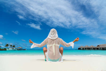 Beach vacation. Hot beautiful woman enjoying looking view of beach ocean on hot summer day.の写真素材