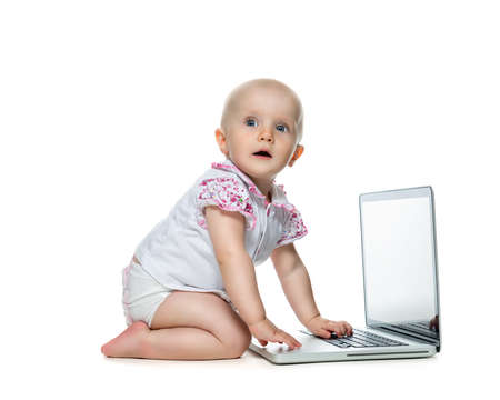 Baby with laptop on the white backgroundの写真素材
