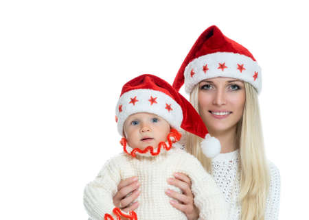 Cute mom and baby in santa hatsの写真素材