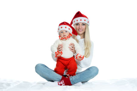 Cute mom and baby in santa hatsの写真素材