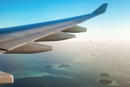 Airplane Wing In Flight over the Maldivesの写真素材
