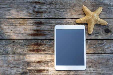 Wooden background with starfish, tadlet and shell - maritime decoration.の写真素材