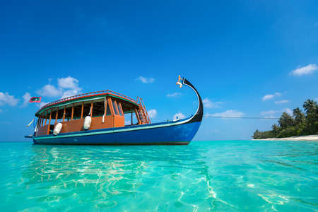 Perfect tropical island paradise beach and boat, Maldivesの写真素材