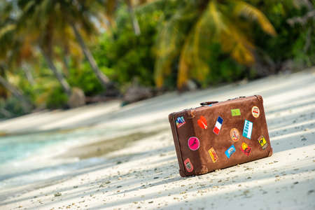 Travel  vintage suitcase is alone on a beachの写真素材