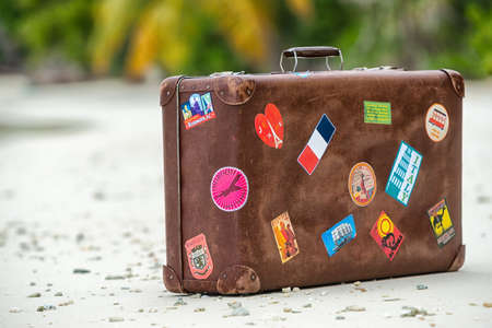 Travel  vintage suitcase is alone on a beach