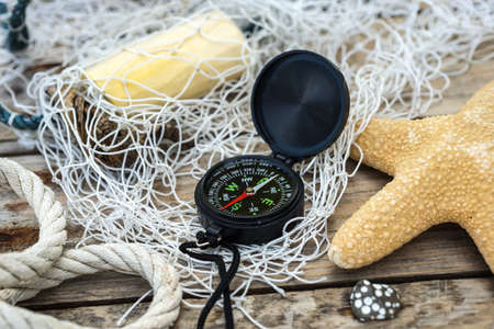 Wooden background with starfish, compass and shell - maritime decoration.の写真素材