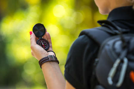 Compass on tourism woman hand against tropical landscape.の写真素材