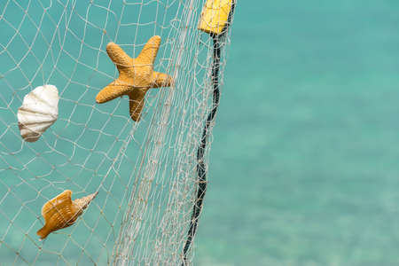 fishing net  on a tropical beach backgroundの写真素材